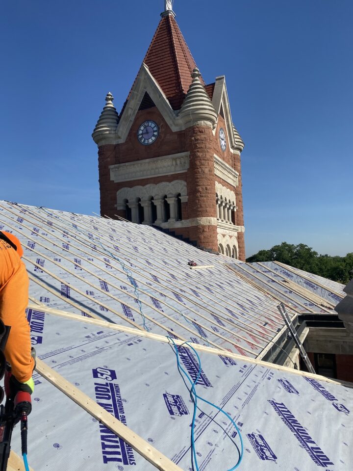Side-shot of old courthouse roof ready for new metal roofing panels