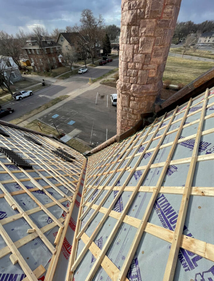 Downward angle image of new wood roofing infrastructure